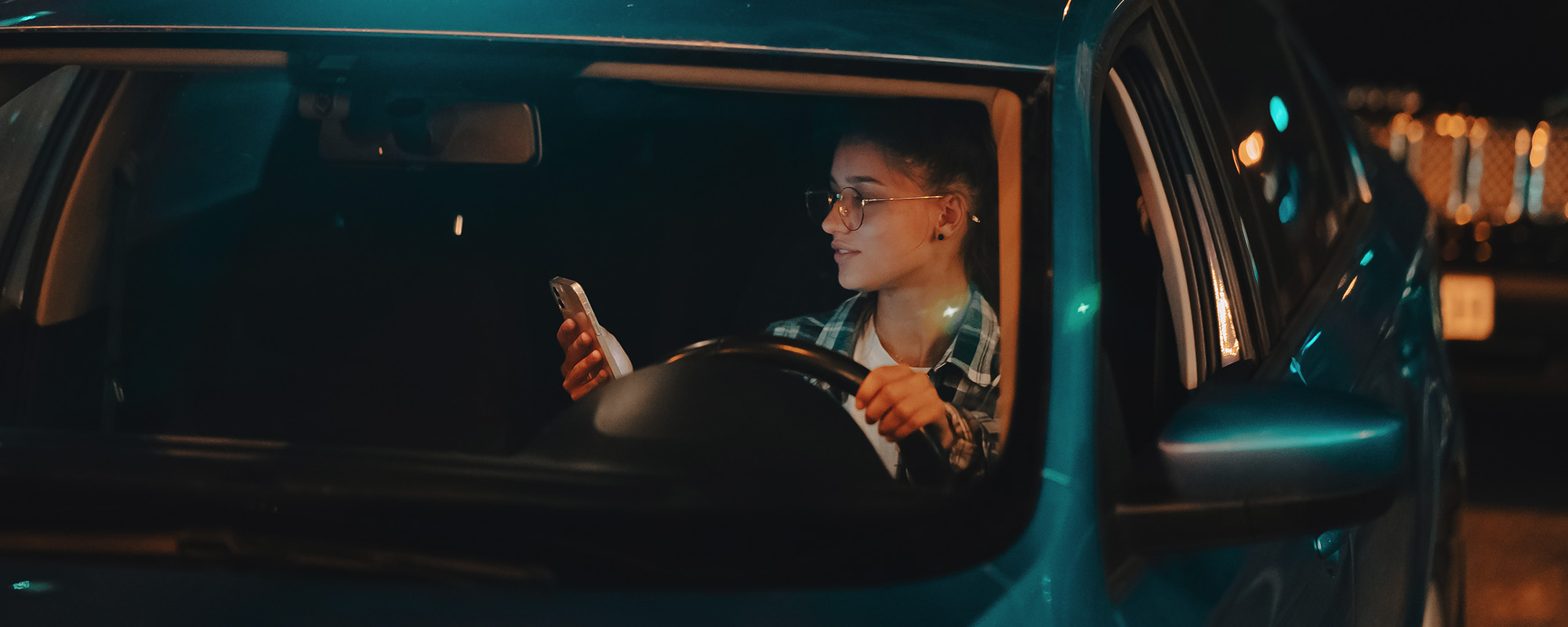 lost female driver using mobile phone while driving at night.