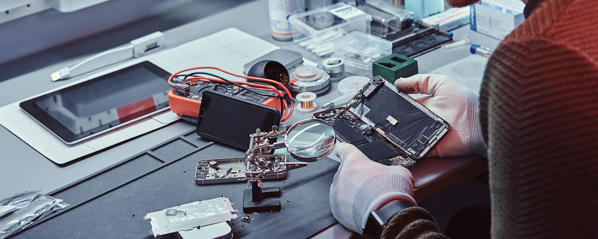 technician carefully examines the integrity of the internal elements of the smartphone in a modern repair shop
