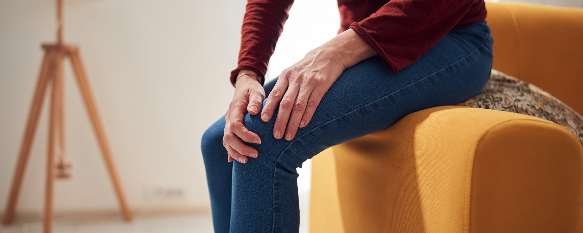 woman with knee and joint pain at home.