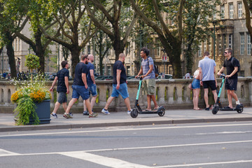 two men riding electric scooters