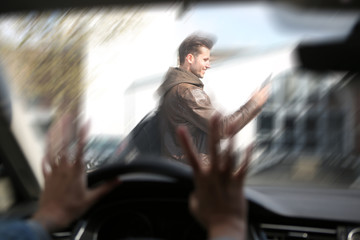pedestrian walking in front of car