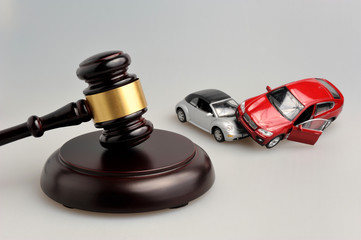 gavel with toy cars in a car accident