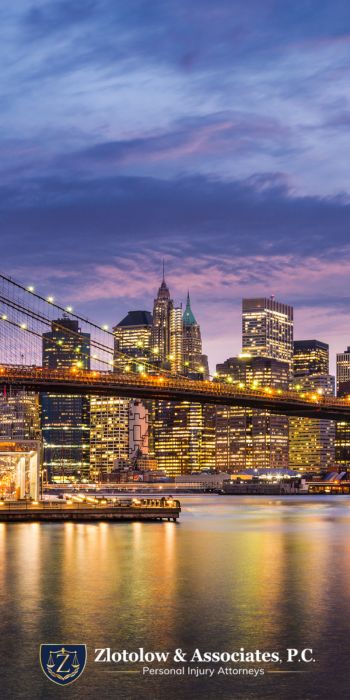 Brooklyn Bridge and Manhattan skyline at dusk with city lights, featuring Zlotolow & Associates, P.C. Personal Injury attorney in Melville NY logo at the bottom.